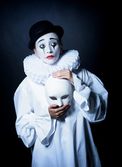 Sad mime Pierrot with a mask