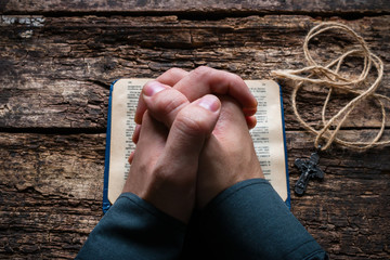 man praying on the Bible selective focus