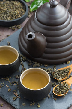 set for tea ceremony on a wooden table, close-up, vertical
