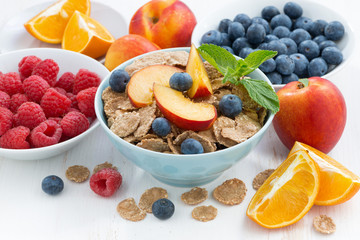 Fototapeta na wymiar whole-grain flakes with fresh fruit and berries