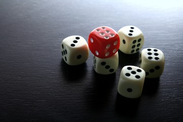 One Red game dice and five white game dice