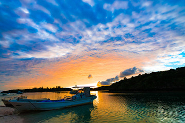 Sunrise, sea, boat, landscape. Okinawa, Japan, Asia.