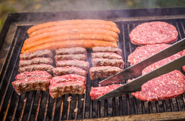 Grilling Meat on barbecue grill with coal.