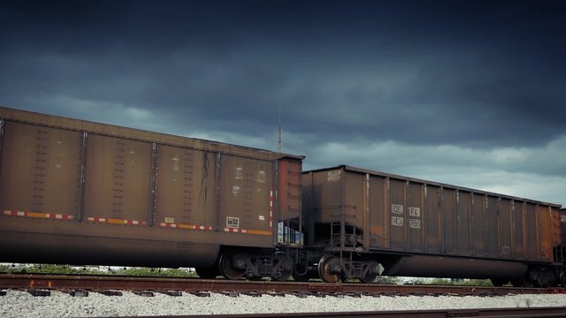 Freight Train Carriages Passing With Dramatic Sky
