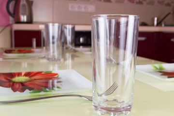 Table setting on red modern kitchen interior background