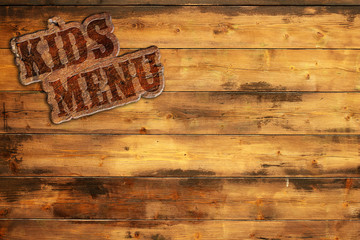 signboard "kids menu" nailed to a wooden wall © Paulista