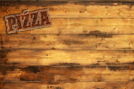 pizza signboard nailed to a wooden wall