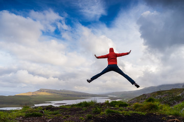 Man jumping on the top pf a mountain, Skye, Scotland