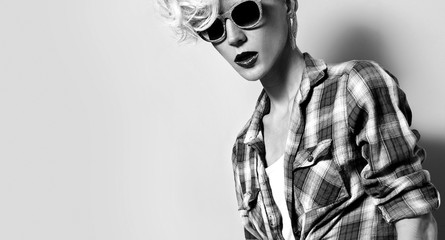 Glamour girl with fashion hairstyle and trendy sunglasses