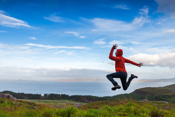 Man jumping on the top pf a mountain, Skye, Scotland
