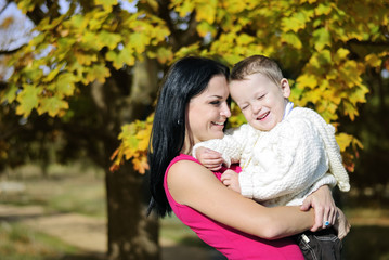 Fototapeta premium little boy with his mother in autumn park
