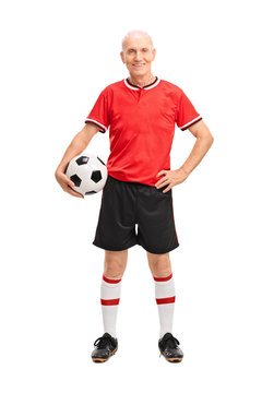 Mature man in a red jersey holding a football