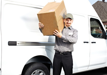 Postman with parcel near delivery truck.