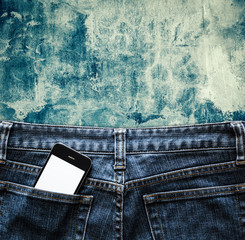 Blue jeans with cell phone in a pocket background - 91337885