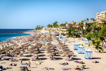 People sunbathing in the picturesque El Duque beach