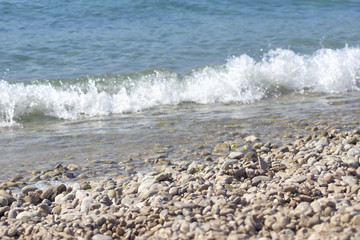 tide the sea on a pebble beach