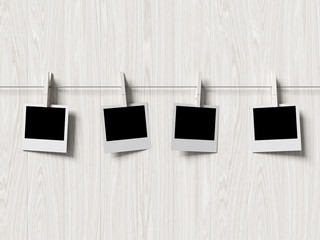 empty polaroid photos frames on wood background