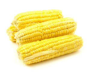 Heap of fresh corns on white