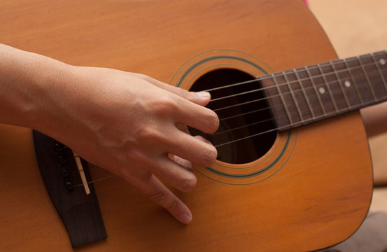 hand playing folk guitar