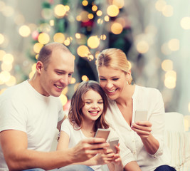 happy family with smartphones
