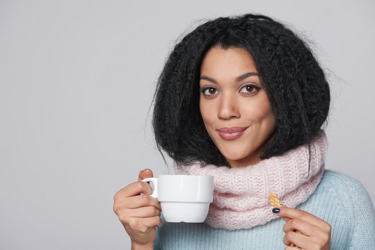 Smiling winter woman with cup of coffee