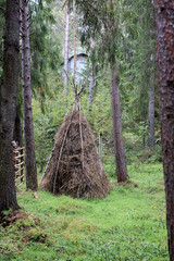 tepee for kids. hut tepee of branches for children to play in the forest © EvgeniiAnd
