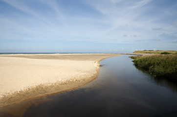 River Liver. Denmark is a flat land and therefore the rivers generated never get to any great size. The river Liver at its mouth running into the North Sea.