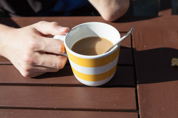 Coffee with milk on a sunny day.
