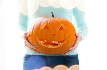 close up of woman with pumpkins at home