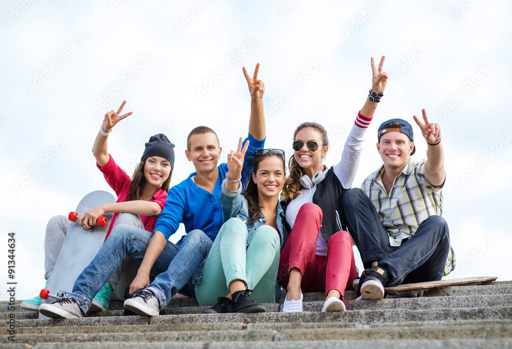 Wall mural group of teenagers showing finger five