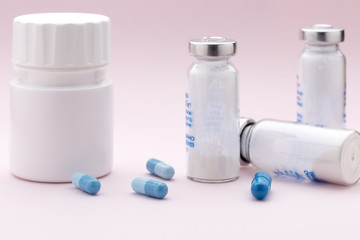 The set of medicine bottles, colorful capsules and injection