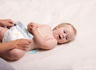 Mom puts on diaper baby