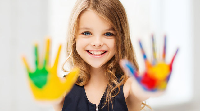 smiling girl showing painted hands