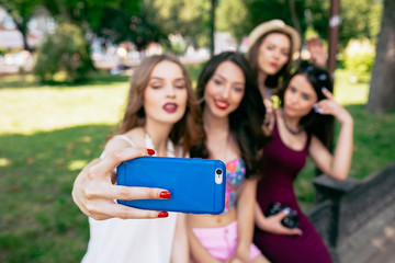 Fototapeta premium four beautiful young girls make selfie 