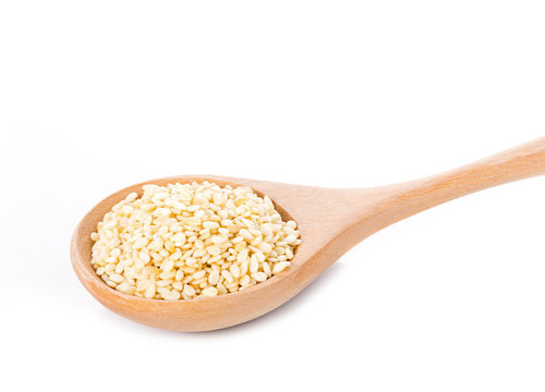 sesame seeds with wooden spoon on white background
