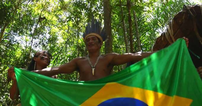 Native Brazilians showing the Brazilian Flag at an indigenous tribe in the Amazon