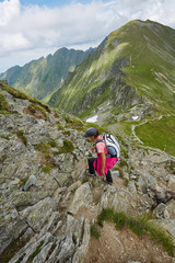 Fototapeta premium Woman hiker on a mountain trail