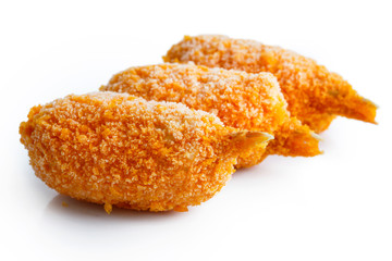 Three frozen breaded surimi crab claws in perspective, isolated