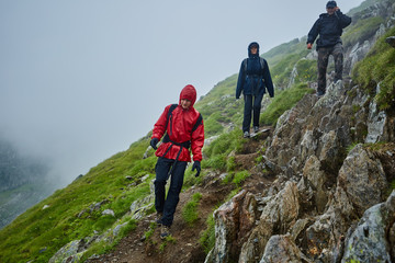 Hikers in raincoats on mountain