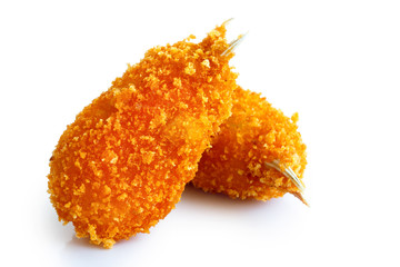 Two fried breaded surimi crab claws, in perspective, isolated on