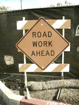 aged and worn vintage photo of road work sign