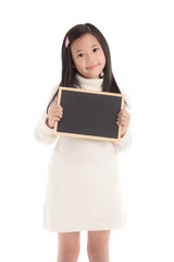 Fototapeta premium Cute asian girl in white turtleneck dress holding blackboard