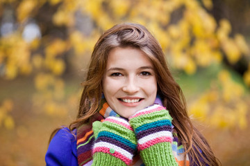 Portrait of beautiful young girl in an autumn park