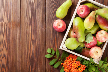 Pears and apples in wooden box
