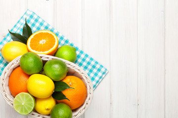 Citrus fruits in basket. Oranges, limes and lemons