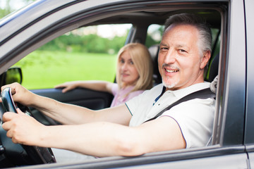 Mature couple traveling in their car