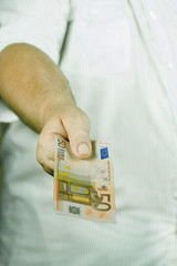 Outstretched hand with euro banknote