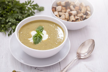 A delicious pea cream with aromatic spices on a wooden table.