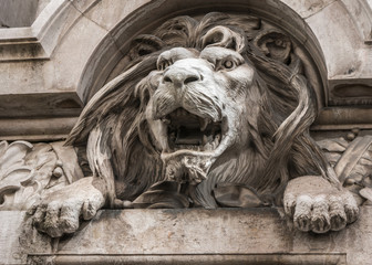 Lion head relief on the facade