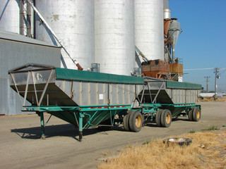 Truck trailer in front of grain elevators
